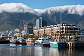 South Africa, Cape Town. Victoria & Alfred Waterfront, Table Mountain in the distance with typical cloud cover called the 'table cloth'.
