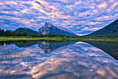 Canada, Alberta, Banff National Park. Reflections in lake at sunrise.