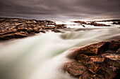 Canada, Nunavut Territory, Blurred image of rushing waterfall near Bury Cove along west coast of Hudson Bay 100 miles south of the Arctic Circle