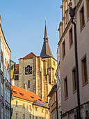 Europe, Czech Republic, Prague. View of steeple and clock in old town Prague.