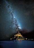 Europe, France. Milky Way over Le Mont St. Michel landmark.