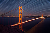 USA, California, San Francisco. Composite of star trails above Golden Gate Bridge.