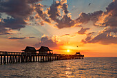 Setting sun over the Naples Pier and Gulf of Mexico, Naples, Florida, USA