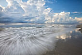 USA; North America; Georgia; Tybee Island; Clouds and waves in morning light at the beach.