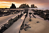 USA, Washington State, Olympic National Park. Sunrise on coast beach and rocks.