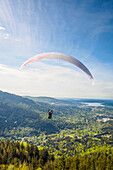 USA, Washington State, Issaquah. Paragliders launch from Tiger Mountain and soar westward towards Issaquah.