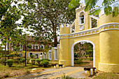 historic entrance gate and mansion of the Roça Belo Monte Hotel on the island of Principé in West Africa