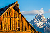 USA, Wyoming, Grand Teton National Park, Jackson, Early morning light on the Mormon Barn in with the Grand Teton in the background.