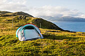 Norway, Lofoten, Tent at sunset over the fjord