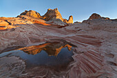 USA, Arizona, Vermilion Cliffs National Monument. Striations in sandstone formations and pool