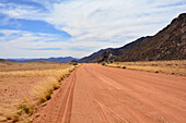 Namibia; Karas region; Southern Namibia; Namib Desert at the Tirasberg Conservancy; red gravel road in the Tiras Mountains