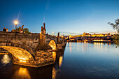 Charles Bridge over the Vltava River and Hradcany Castle in Prague, Czech Republic, at night