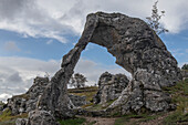 Rock arch with rock formations in the background. Rauka. Larbro Gotland, Sweden