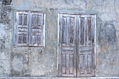 Africa, Madagascar, Fort Dauphin, Tolanaro marketplace. A shuttered home showing the muted colors of weathered wood.