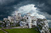 Europe, Poland. Storm clouds over Ogrodzieniec Castle.