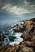 USA, California. Clouds approaching the cliffs and surging waves at Bodega Head, Sonoma Coast State Beach ()
