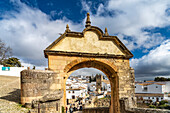 Archway Arco Felipe V and the white houses of the old town with the church Iglesia de Padre Jesús, Ronda, Andalusia, Spain