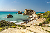 Tour group at Petra tou Romiou, the rock of Aphrodite on the coast in Kouklia near Paphos, Cyprus, Europe
