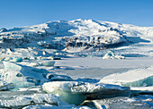 Glacier Fjallsjoekull and frozen glacial lake Fjallsarlon in Vatnajokull National Park during winter. Iceland.