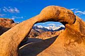 Dawn light on Mount Whitney through Mobius Arch, Alabama Hills, Inyo National Forest, California, USA