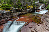 Red rocked Virginia Creek in Glacier National Park, Montana, USA ()
