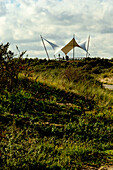 Dutch dune landscape with tensioned sail as shelter