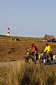 Cyclists in front of the Ostellenbogen lighthouse, Sylt, North Friesland, North Sea, Schleswig-Holstein, Germany, MR