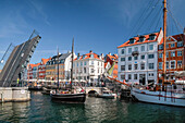 Drawbridge with sailing boat in Nyhavn in Copenhagen, Denmark