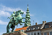 Equestrian statue of Absalon and the tower of St. Nicholas Church on the central square Højbro Plads in Copenhagen, Denmark, Europe