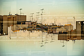 Double exposure photograph of the rooftops of Milan in the setting sun, Italy.