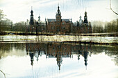 Double exposure of the fairytale castle of Ooidonk in the Ghent municipality in Belgium