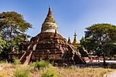 An ornate brick temple with a white spire at the Bagan archaeological site in Myanmar