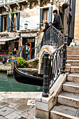 Venice - water alley with gondola, bridge and railing