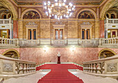 The Hungarian State Opera House, built in the 1880s, interior double staircase with a red carpet.