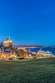 Chateau Frontenac, lit up at night in Quebec City, view over the St Lawrence river.