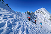 Three people on a ski tour ascending the Höllensteinkar, Höllensteinkar, Tux Valley, Zillertal Alps, Tyrol, Austria