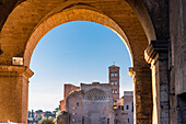The temple of Venus and Mars seen under the columns of the Colosseum in Rome, Italy