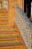 Spain, Seville, Tiled steps and balustrade of arch bridge