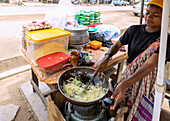Food stall selling fried noodles, in Ntonso north of Kumasi in the Ashanti Region of central Ghana in West Africa