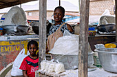 Selling cassava flour and tapioca at the weekly market in Techiman in the Bono East region of central Ghana in West Africa