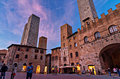 Evening mood at the Piazza della Duomo, San Gimignano, Province of Siena, Tuscany, Italy