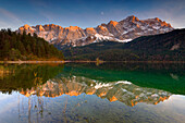 Alpenglow on the Zugspitze massif with reflection in the Eibsee.