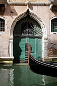 Partial view of a gondola in front of an archway, Venice, Venezia, Venetia, Italy, Europe