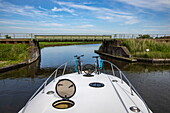 Bow of a Le Boat Elegance houseboat about to pass under a particularly low bridge, near Hindeloopen, Friesland, The Netherlands, Europe