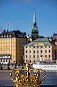 Golden Crown on Skeppsholmen Bridge with Gamla Stan Old Town behind, Stockholm, Stockholm, Sweden, Europe