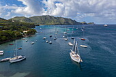 Aerial view of sailboats in port and expedition cruise ship World Voyager (nicko cruises) in the distance, Bequia Island, Grenadines, Saint Vincent and the Grenadines, Caribbean