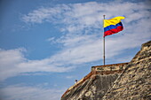 Colombian flag flies at the Castillo San Felipe de Barajas fortress, Cartagena, Bolívar, Colombia, South America