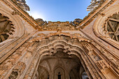 Magnificently decorated portal of the chapel of the Batalha monastery complex with sun star and small aperture, Portugal