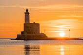 Sunrise behind the Isola della Bocca lighthouse, Olbia, Sardinia, Italy