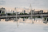 Double exposure of the Golden Jubilee Bridge crossing the river Thames in London, UK.